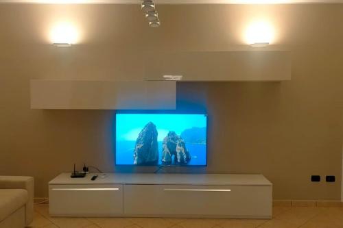 a living room with a flat screen tv on a wall at La casa smart zona stadio in Terni
