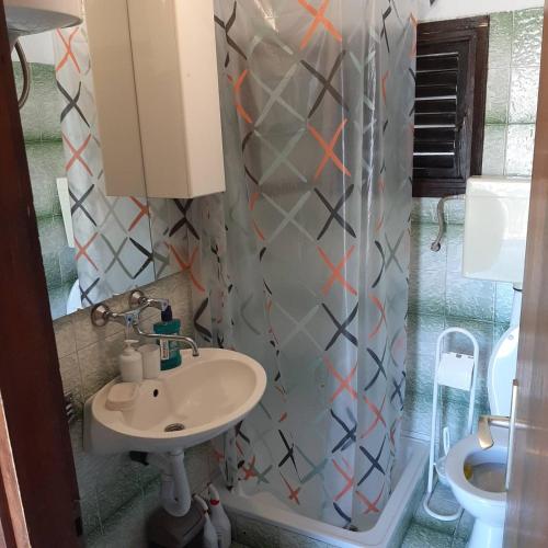 a bathroom with a sink and a toilet at Apartman Mare BP in Dolac
