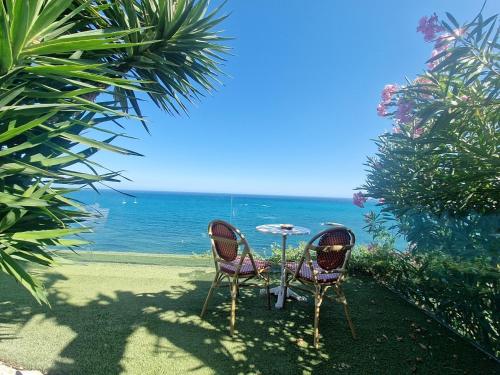 two chairs and a table in front of the ocean at Condesa del Mar adults only in Altea