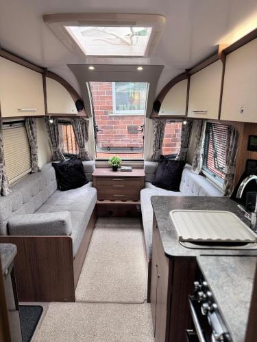 an interior of an rv with couches and a kitchen at Tayys Inn Luxury Camp in Birmingham