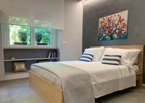 a bedroom with a large bed with two pillows at Casa Armonia Apartment Sulmona in Sulmona