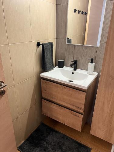 a bathroom with a sink and a mirror at Number 10 @ Coralli in Protaras