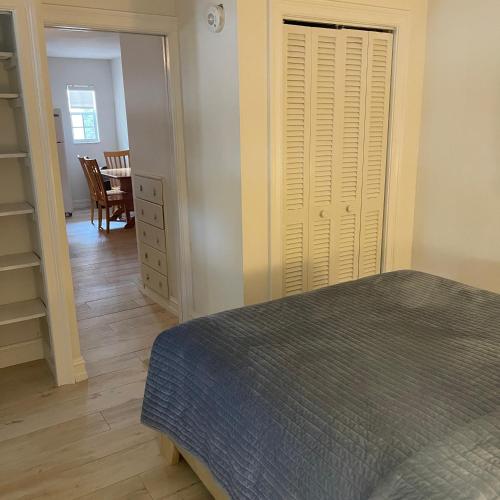 a bedroom with a bed and a closet and a dining room at Kings Kamp in Key Largo