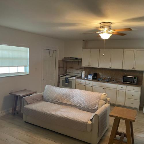 a living room with a couch and a kitchen at Kings Kamp in Key Largo