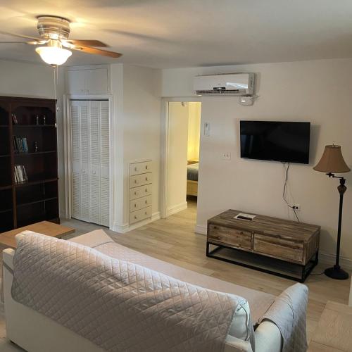 a living room with a couch and a flat screen tv at Kings Kamp in Key Largo