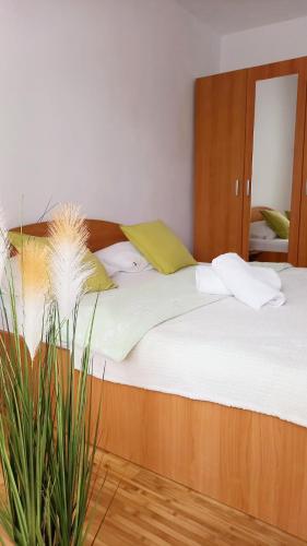 a bedroom with a large bed with white sheets at CLASSY 2-Dormitoare in Baia Mare
