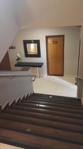 a room with a door and stairs in a building at Hotel Pouso Novo in Matão