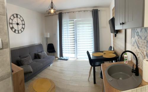 a living room with a couch and a table at Przystanek Karpacz - ul Słowackiego 5A in Karpacz