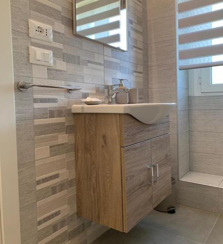 a bathroom with a sink and a mirror at Casa Armonia Apartment Sulmona in Sulmona