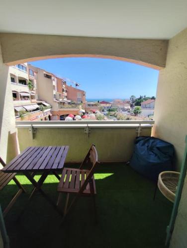 d'un balcon avec une table en bois et un banc. dans l'établissement Belle vue odyssée 80, à La Croix-Valmer