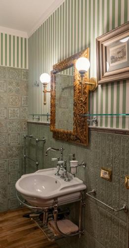 a bathroom with a sink and a mirror at Regal House Verona Vescovado in Verona