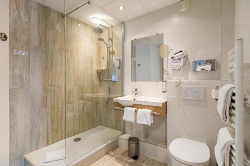 a bathroom with a sink and a toilet and a shower at Best Western Les Bains Hotel et SPA in Perros-Guirec