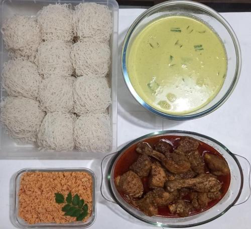 a tray of food with rice and meat and a bowl of dip at Spacious Eco House with Garden and Scenic Paddy View Colombo in Malabe
