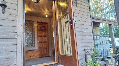 a wooden door to a house with a porch at Vabaduse Guesthouse in Narva-Jõesuu