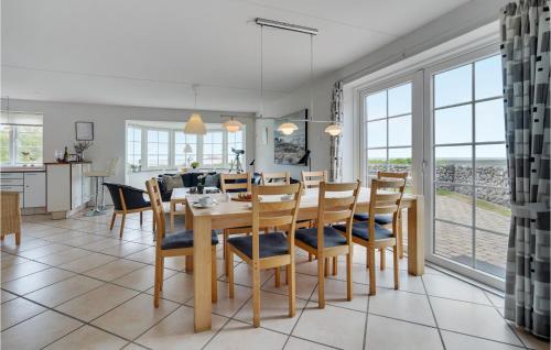 a dining room and kitchen with a table and chairs at Holiday Home Sdr Frankel Rømø in Rømø Kirkeby