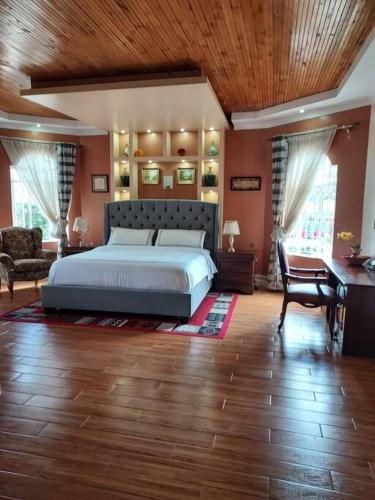 a bedroom with a large bed and a desk at 8 bedroom in Nanyuki with pool in Ol Pejeta Conservancy