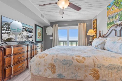 a bedroom with a large bed and a television at Dottie's Sandbar in Navarre