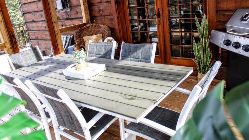 a wooden table and chairs on a patio at Chalet des Sources SPA Gazebo panoramique in Mont-Blanc