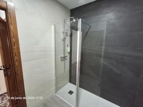 a shower with a glass door in a bathroom at Conde Lucanor in Belmonte