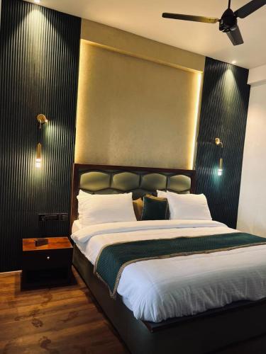 a bedroom with a large bed with a black headboard at Villa Aven - Premium Suits in Kakkadampoyil