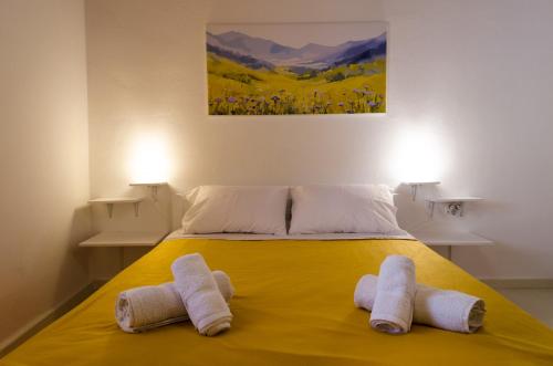 ein Schlafzimmer mit einem Bett mit Handtüchern darauf in der Unterkunft Marini Traditional Cottages in Khlóï