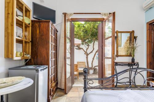a kitchen with a door open to a patio at Yianna Sunny Studios in Skopelos Town