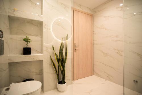 a bathroom with a toilet and a glass shower at Kogevinas Hill Luxurious Apartments in Alepou