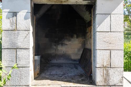 an opening in a brick wall with a tunnel at Stephanie green island apartments in Šipanska Luka