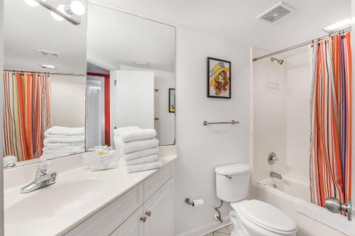 a white bathroom with a sink and a toilet at Windward Pointe 1401-Large balcony best views in Orange Beach