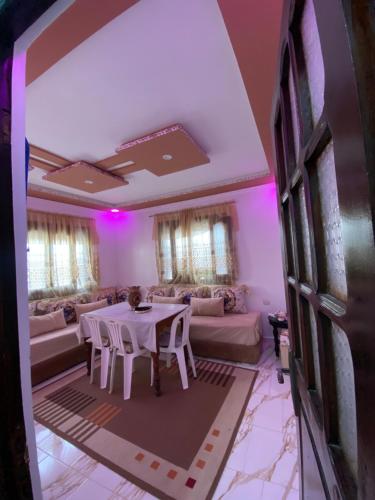 a living room with a table and a couch at Dar andalouse in Chefchaouene