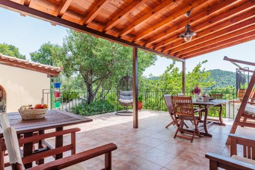 an outdoor patio with a table and chairs at Pefkos Cottage in Panormos Skopelos