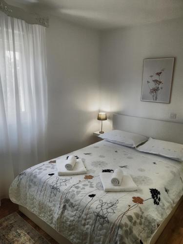 a bedroom with a bed with two towels on it at Astralis in Trogir