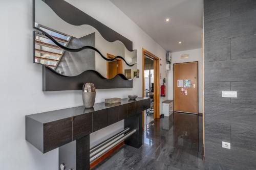 a hallway with a console table in a house at Vila Cantinho Algarvio Vista Rio in Ferragudo