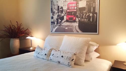 a bedroom with a bed with a red double decker bus at Orenco Lofts in Hillsboro