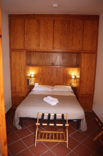 a bedroom with a bed with a wooden wall at Casa Rustica in Conversano