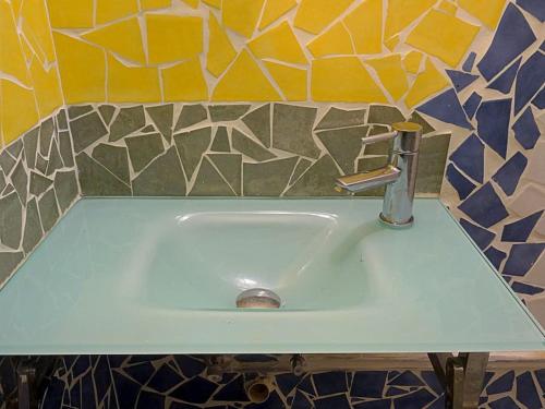 a white sink in a bathroom with a tile wall at Terres de l'Ebre experience in Ulldecona