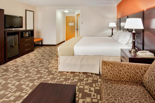 a hotel room with a large bed and a couch at Holiday Inn Express Wilkes Barre East, an IHG Hotel in Wilkes-Barre