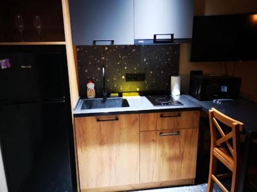 a small kitchen with a sink and a stove at Avilion Apartments Anj 7 1 in Tbilisi City