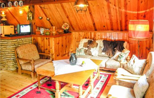 a living room with a couch and a table at Holiday Home Kaminsko Uljalowcowa in Kamińsko