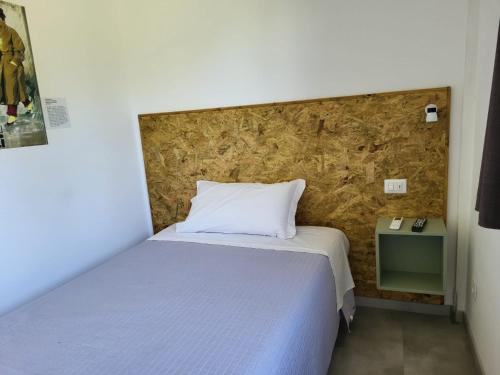 a small bedroom with a bed and a stone wall at Casa MaLa’ in Ceprano