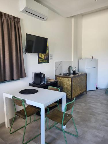 a room with a white table and chairs and a refrigerator at Casa MaLa’ in Ceprano