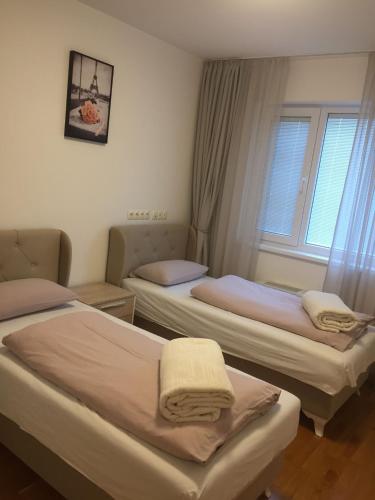 a room with two beds and a window at شقة نهر اليجا in Sarajevo