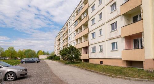 a car parked next to a large building at Kitse 26 Apartment- FREE PARKING in Pärnu
