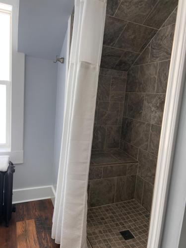 a shower with a shower curtain in a bathroom at Hudson House Bed and Breakfast in Wheatland