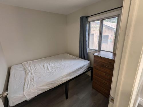 a small bedroom with a bed and a window at Modern Tiny Wood Cottage 04 in Wasaga Beach