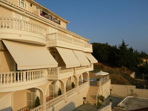 a large building with a balcony overlooking a river at Corali Beach in Tsilivi