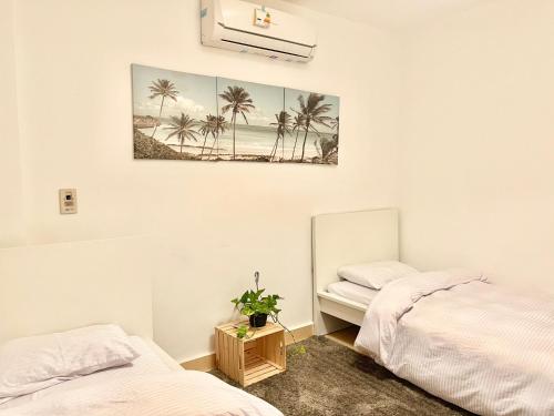 two beds in a room with a picture on the wall at Madinaty Royal Elite Residence in Madinaty