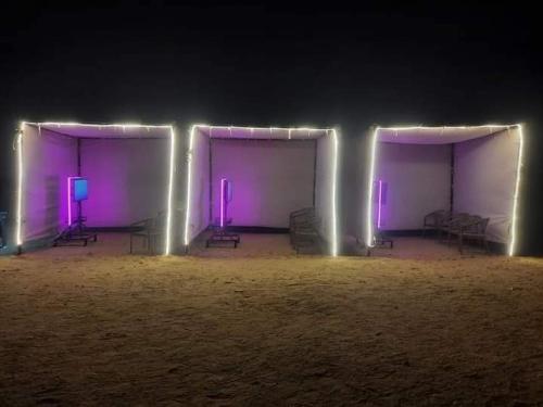 a room with purple lights in the dark at لاسرينا عيون موسي راس سدر أرضي بجاردن فيو بحر وعلي البيسين للعائلات فقط in Ras Sedr
