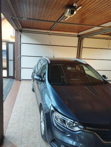 a blue car parked in a garage at садиба Лоньяї 22 in Berehove