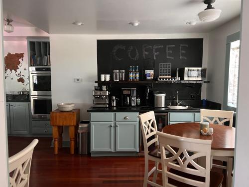 a kitchen with a table and chairs and a coffee shop at Hudson House Bed and Breakfast in Wheatland